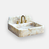 calacatta gold fluted marble sink with backsplash