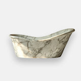 This image shows a Petals marble bathtub with soft white tones and flowing gray veining, designed for elegant bathroom interiors.
