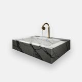 veined white marble rectangular sink with brass tap